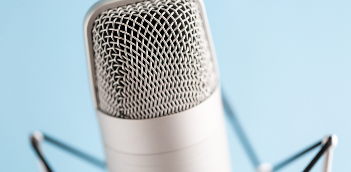 Close up of a microphone against a light blue background