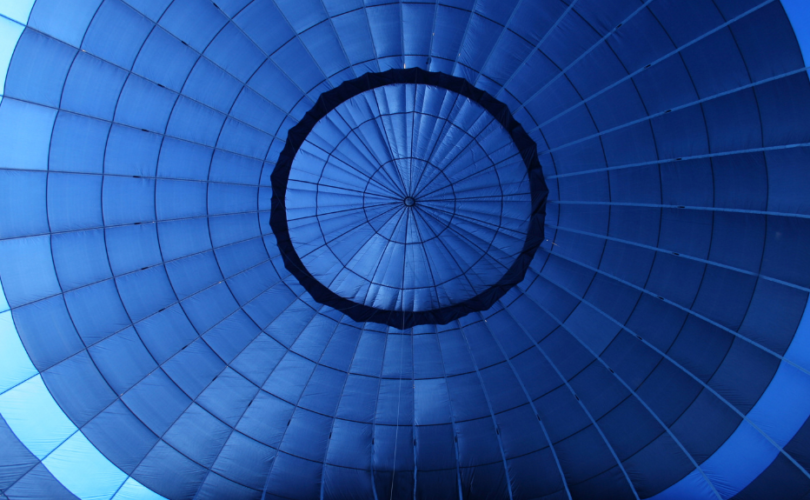 The inside of a teardrop shaped blue hot air balloon