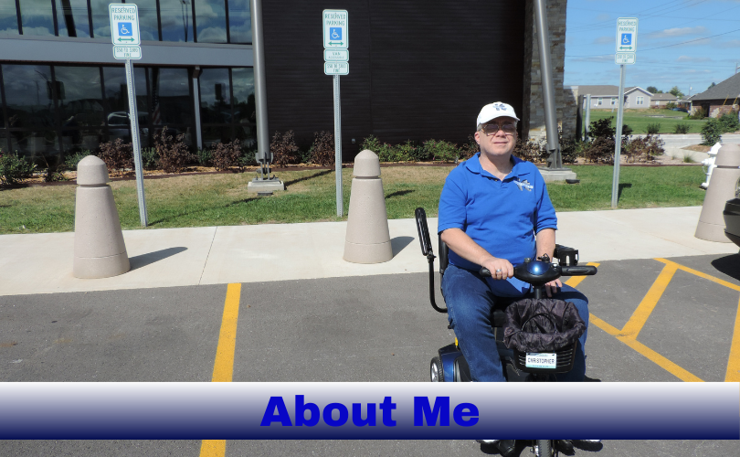 Chris Mitchell, wearing a white baseball cap, glasses and a blue polo shirt and jeans, is sitting on a black and blue scooter in a parking spot an a sunny afternoon. Behind Chris are 3 disabled parking signs, a sidewalk with vertical barriers, grass and a building. Off in the background are some homes, bushes, a blue sky with some white and gray clouds., and the edge of a vehicle. Along the bottom of the image is a bar that transitions from white at the top to navy blue at the bottom. In this bar, appearing in vibrant blue text, “About Me”