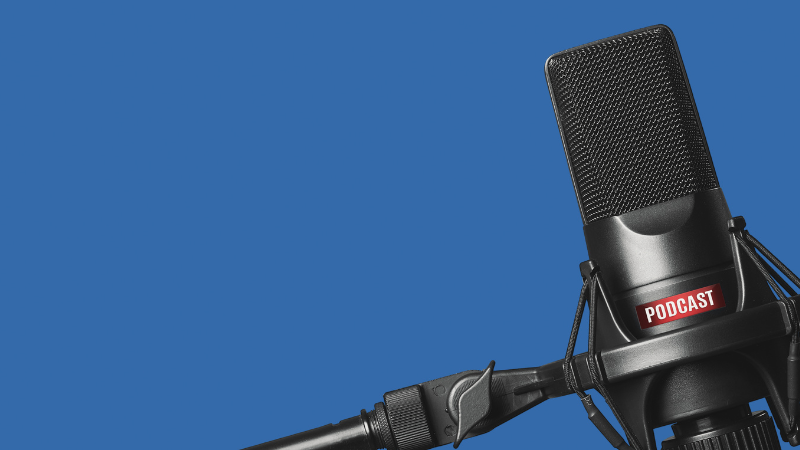 A broadcast microphone with a dark denim blue background