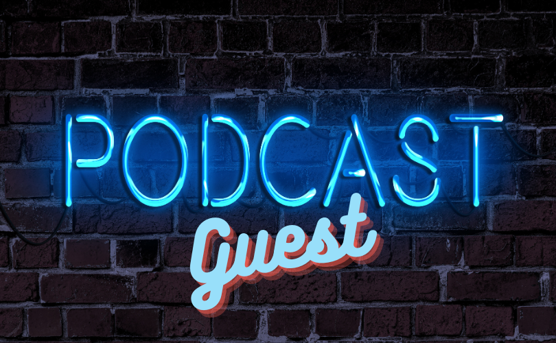 Brick wall with a neon blue sign reading “Podcast Guest”